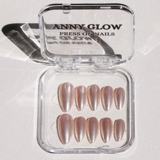 A set of almond-shaped press-on nails in a clear plastic box, featuring a sleek, metallic silver mirror finish for a bold and reflective look.